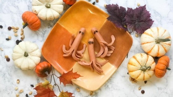 Octopus hot dogs on fall-themed plate